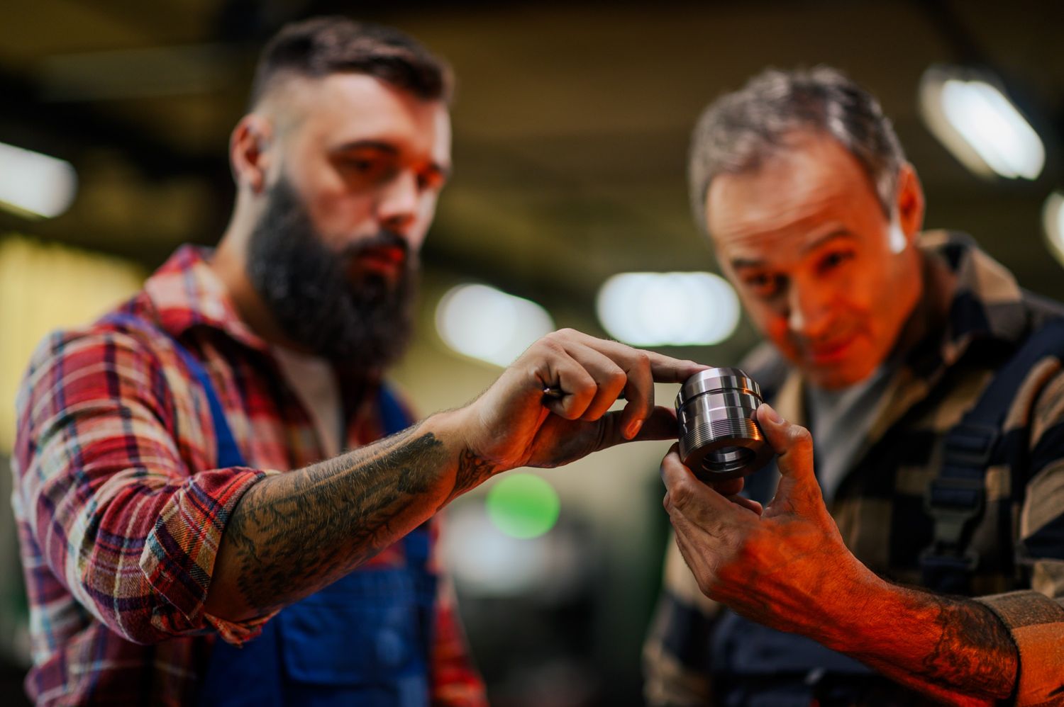 selective focus on hands examining a metal part bl zxglfhn